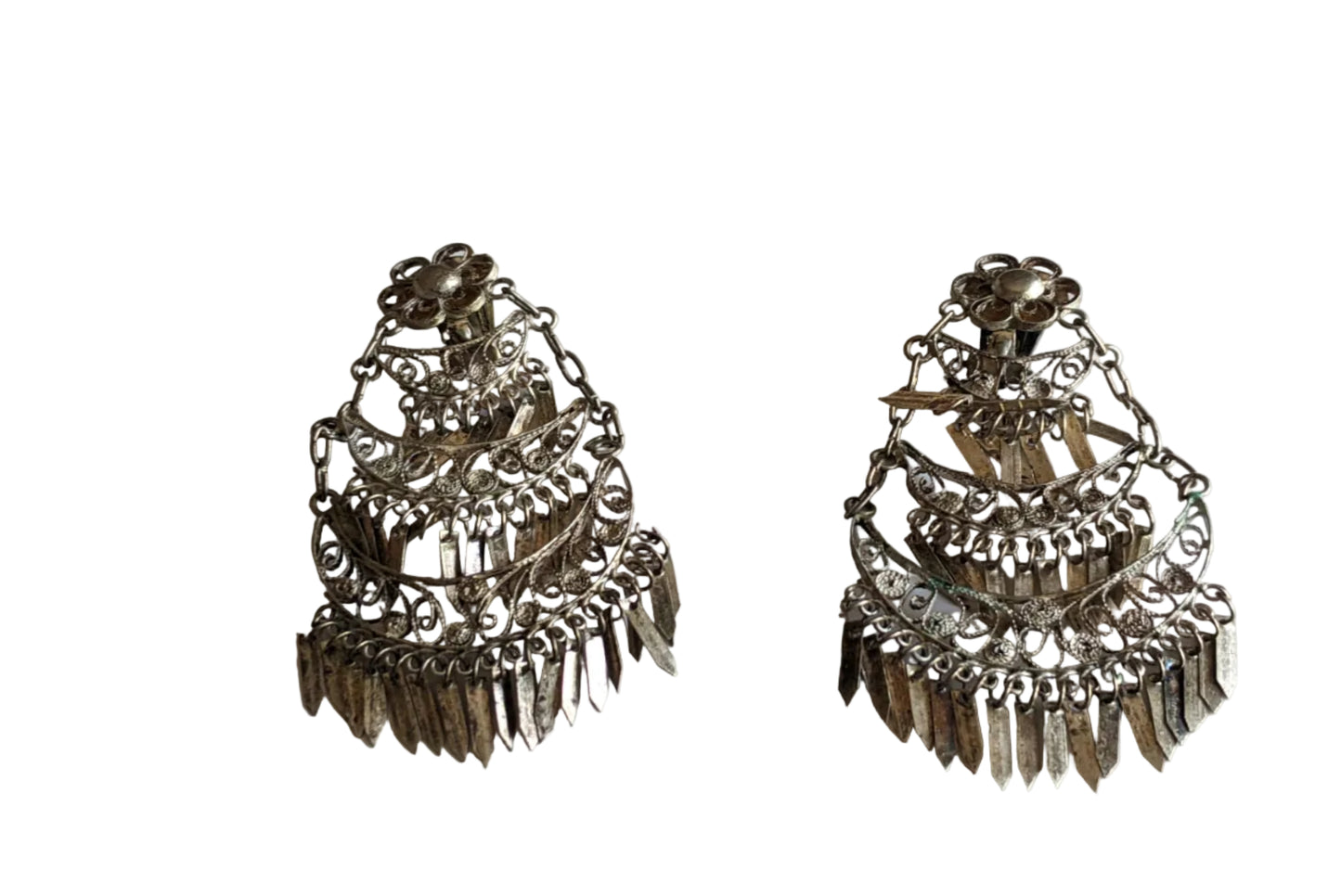 Pair of silver earrings on a light background