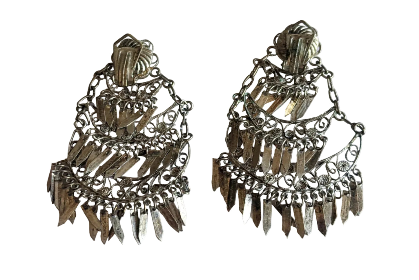 Pair of silver fringe earrings showing the back with the clip on mechanism on a white background