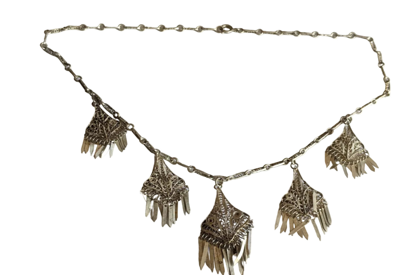 Silver necklace with fringe pendants on a white background