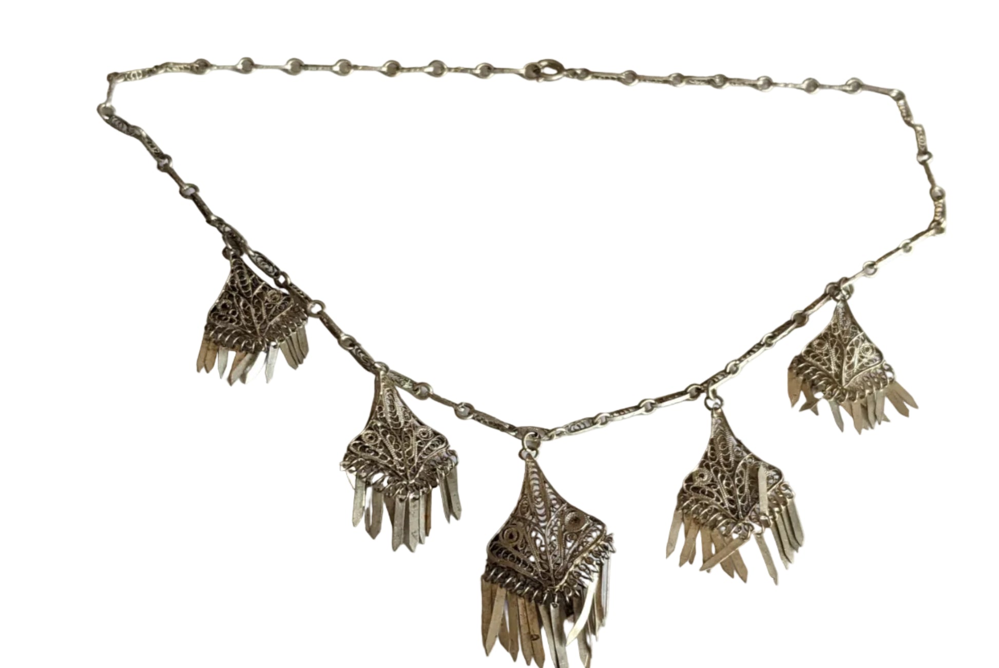 Silver necklace with fringe pendants on a white background