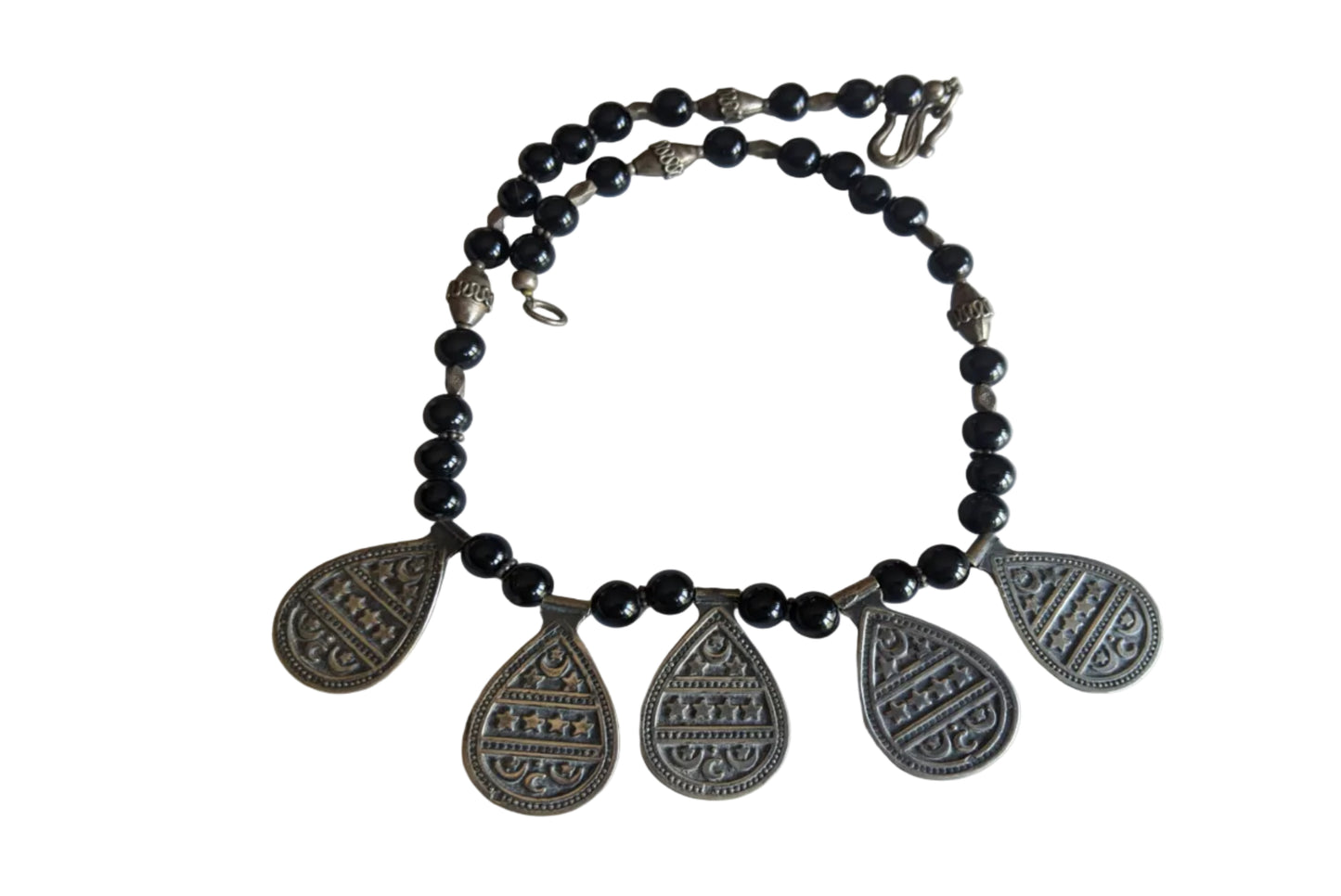 Necklace with black beads and silver teardrop pendants on a white background