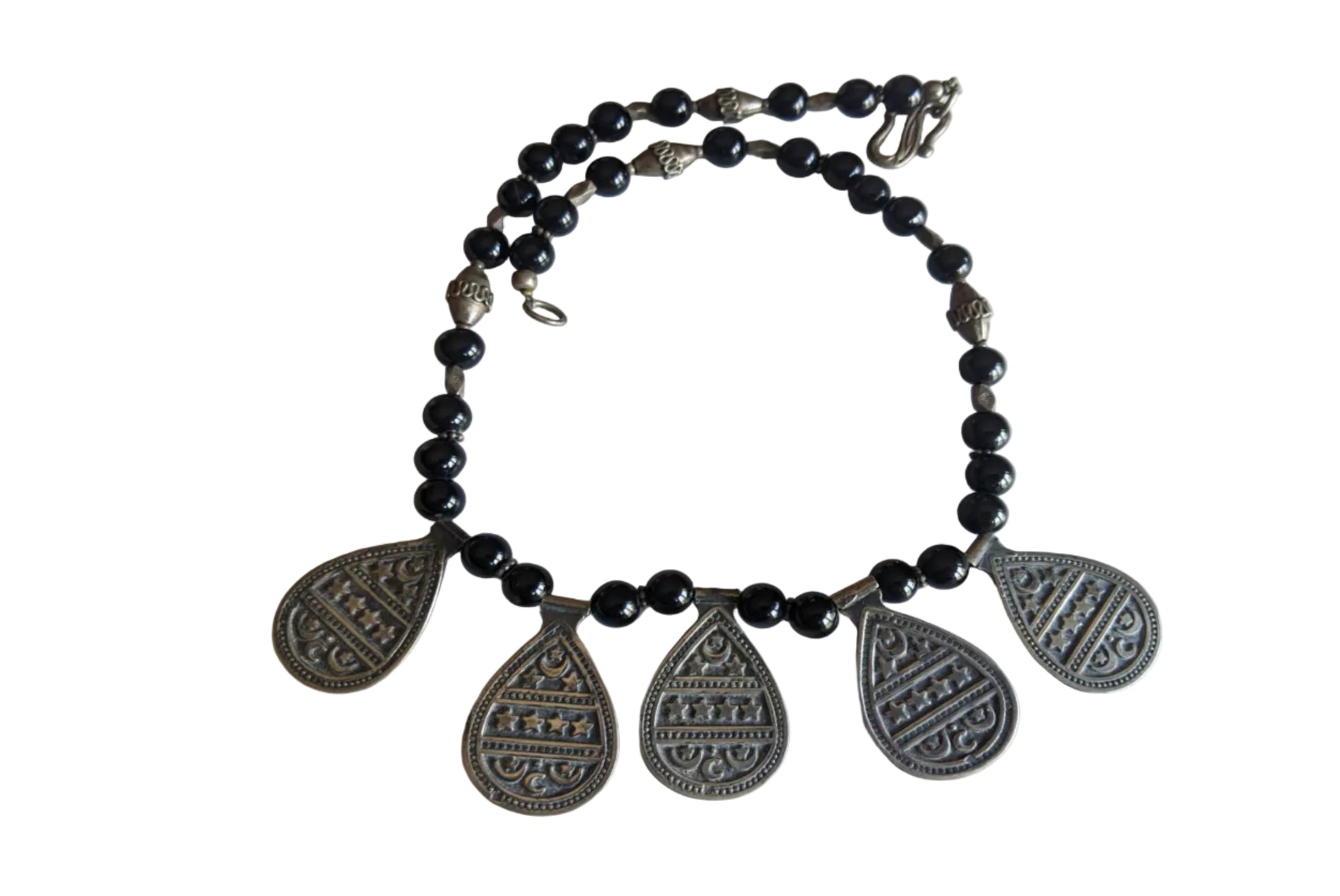 Necklace with black beads and silver teardrop pendants on a white background