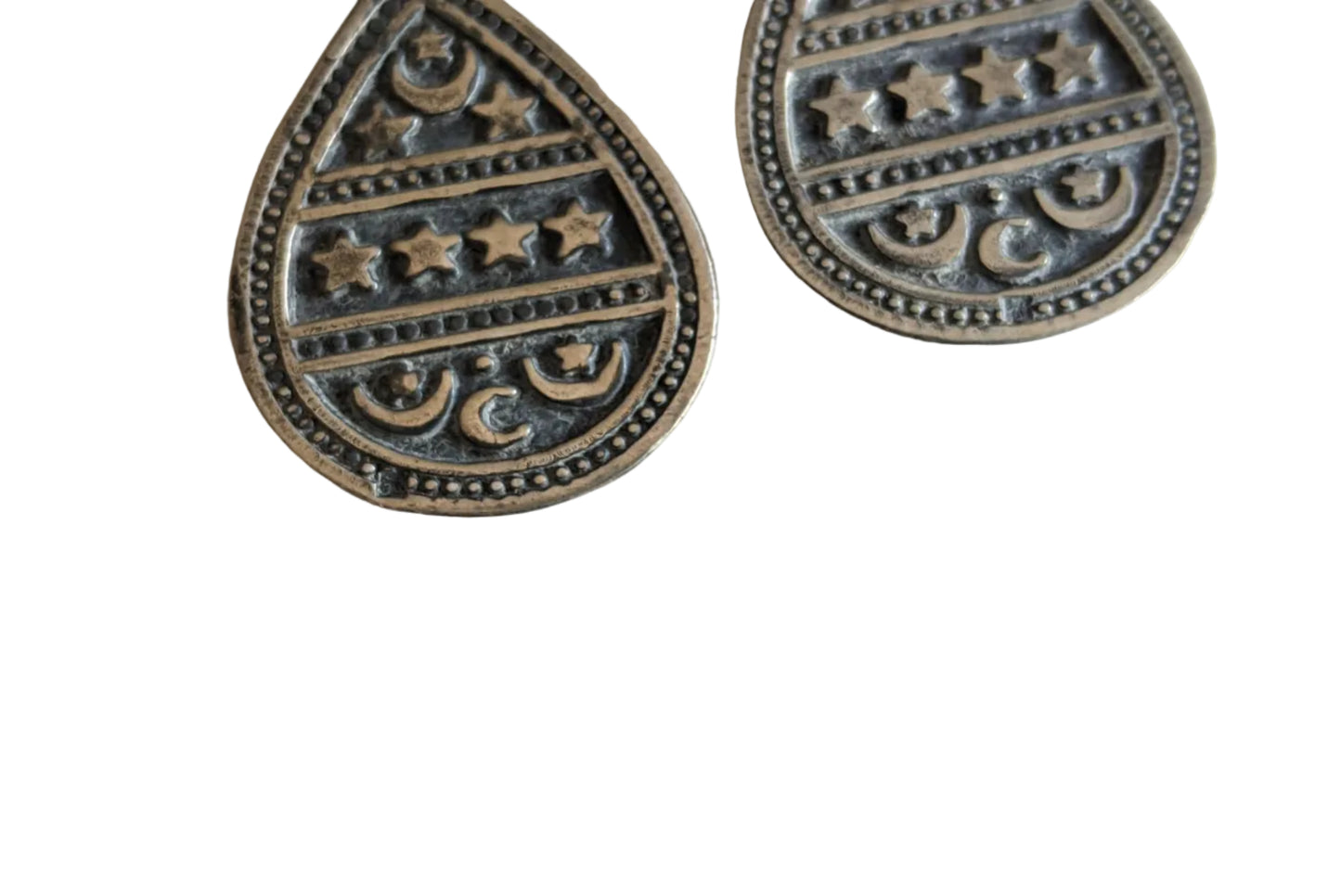 Teardrop-shaped celestial pendants on a white background