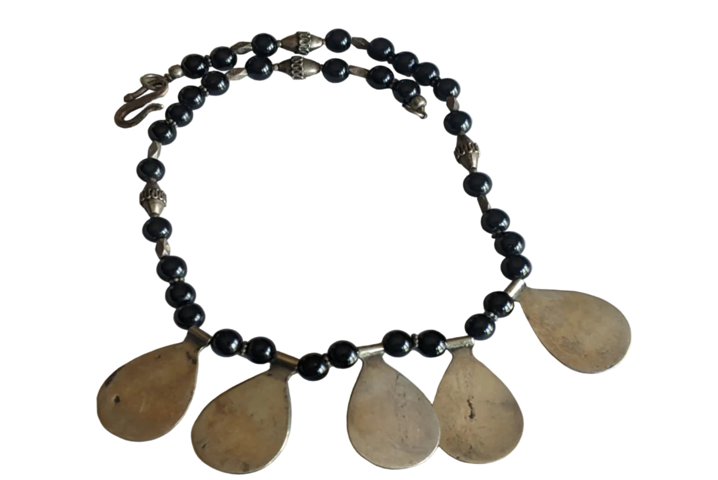 The back of an Egyptian necklace with onyx beads and silver teardrop pendants on a white background