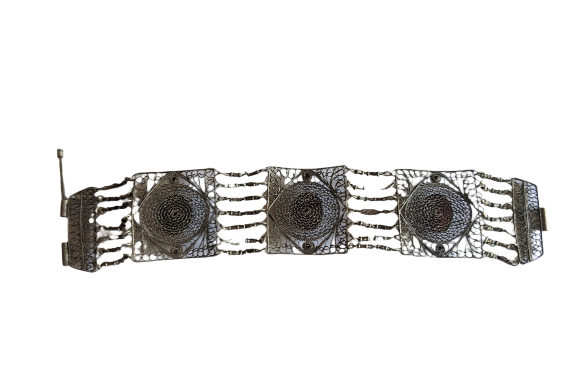 Silver bracelet with intricate design on a white background