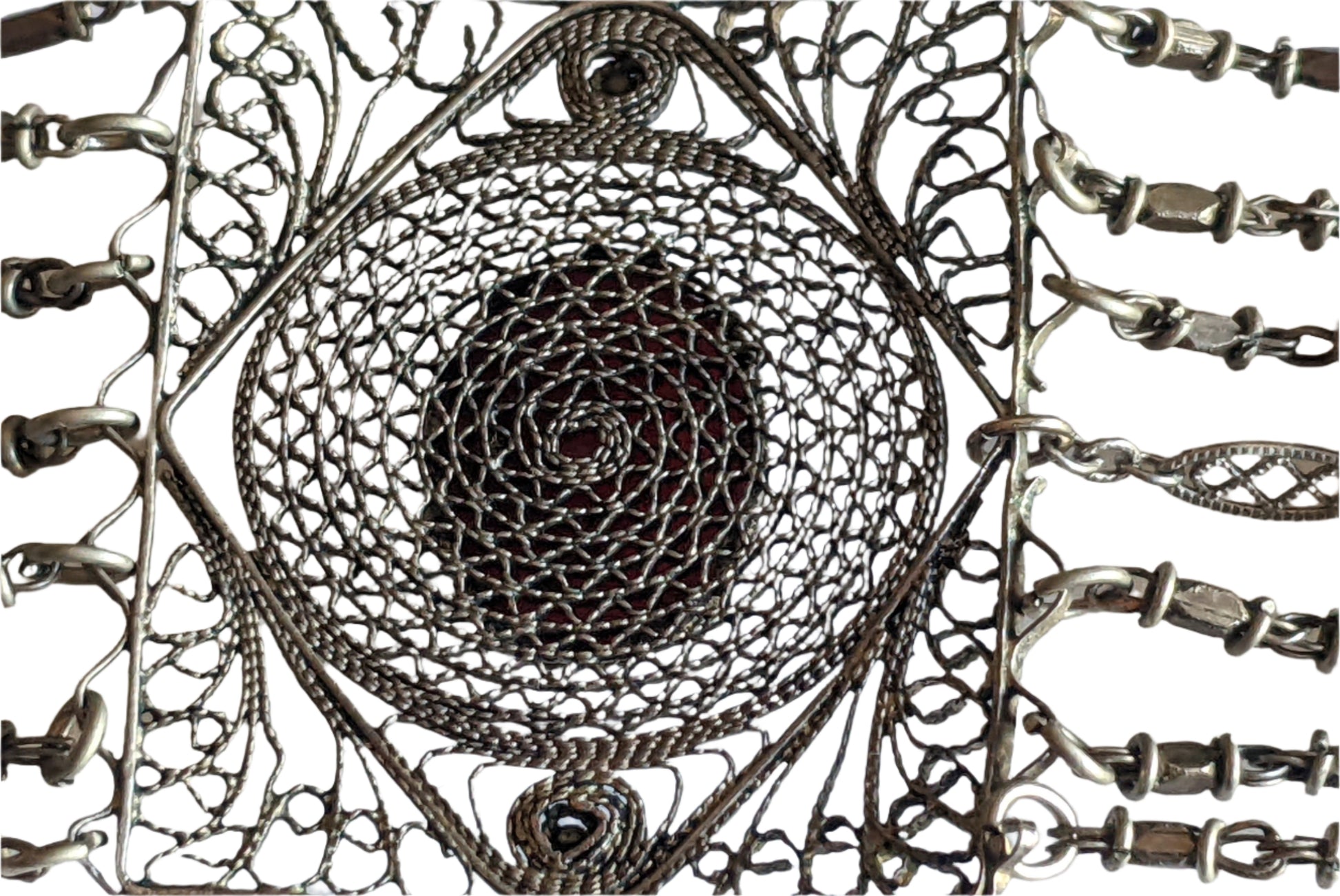 Close-up of intricate silver filigree link bracelet with detailed patterns