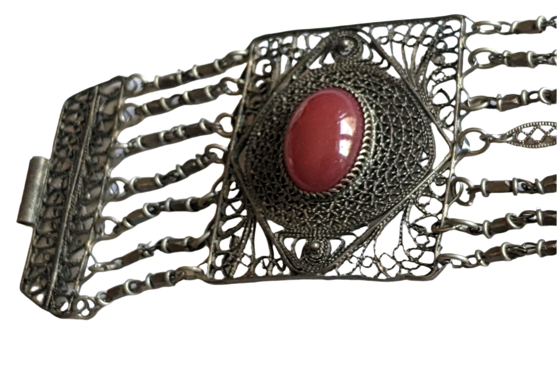 Decorative silver bracelet with a carnelian central stone on a white background