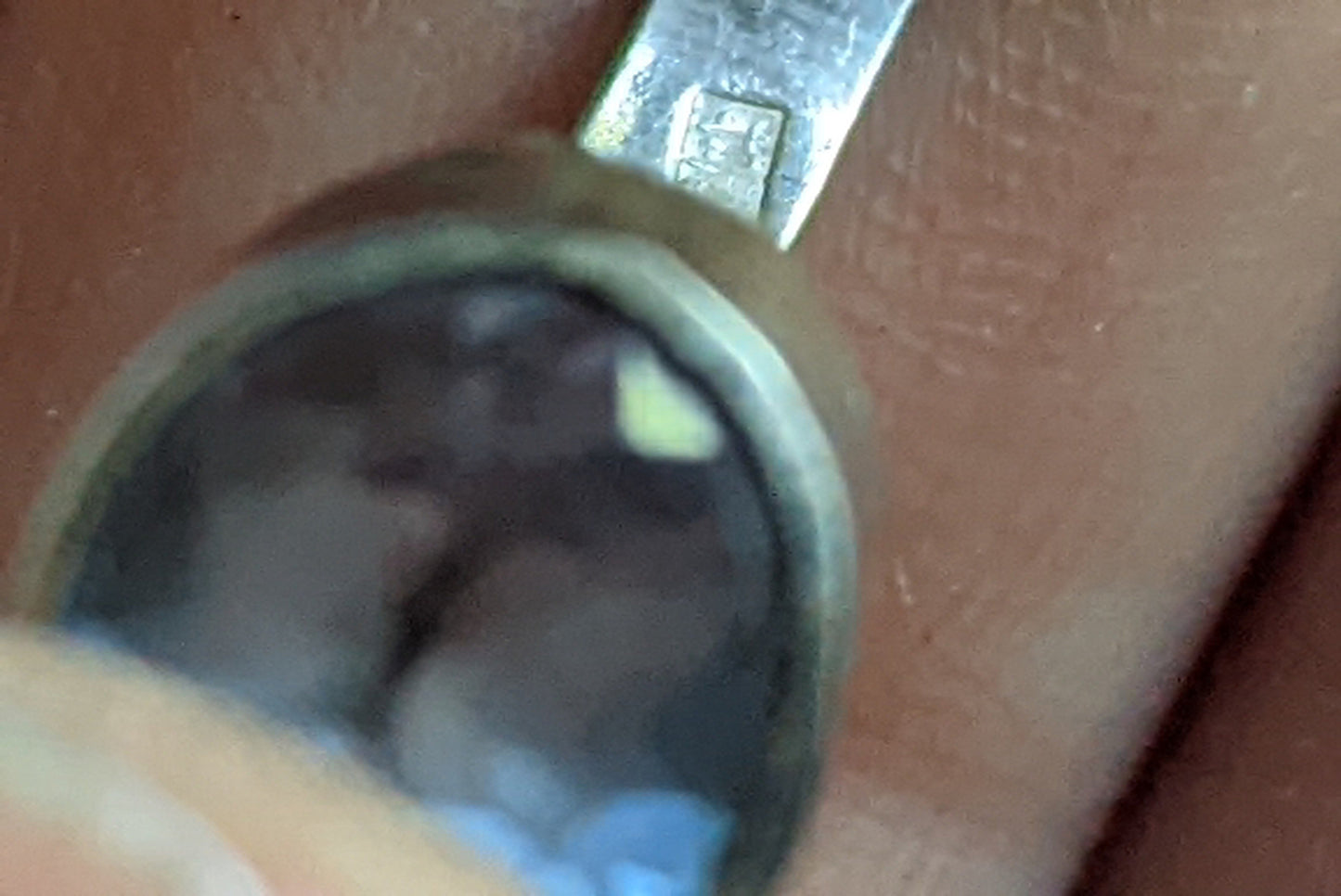 Close-up of a silver assay mark for 90% pure silver.