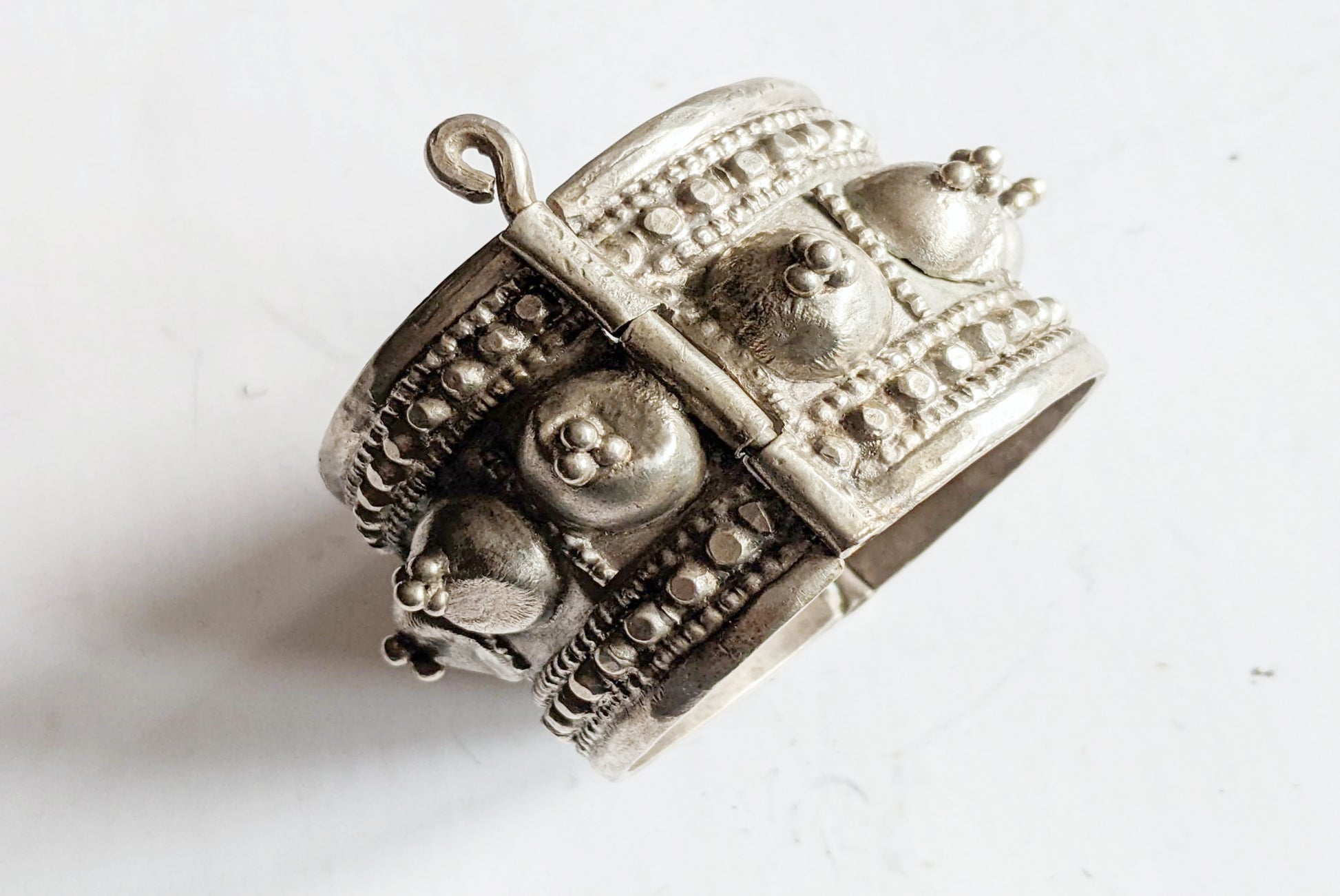 Silver decorative object on a white background