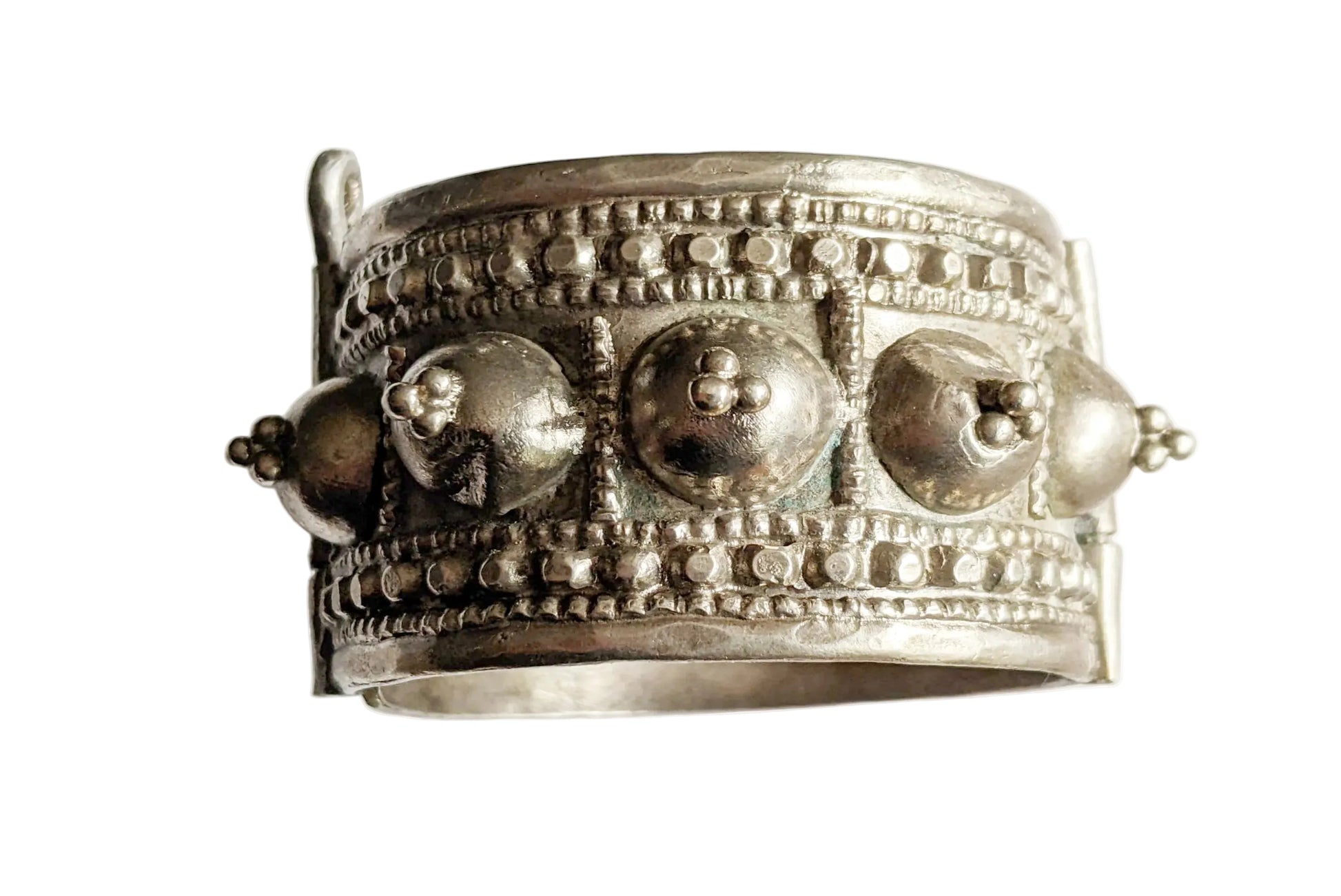 Silver bracelet with intricate designs on a white background