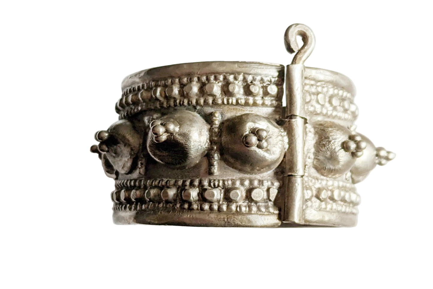 Silver bracelet with intricate designs on a white background
