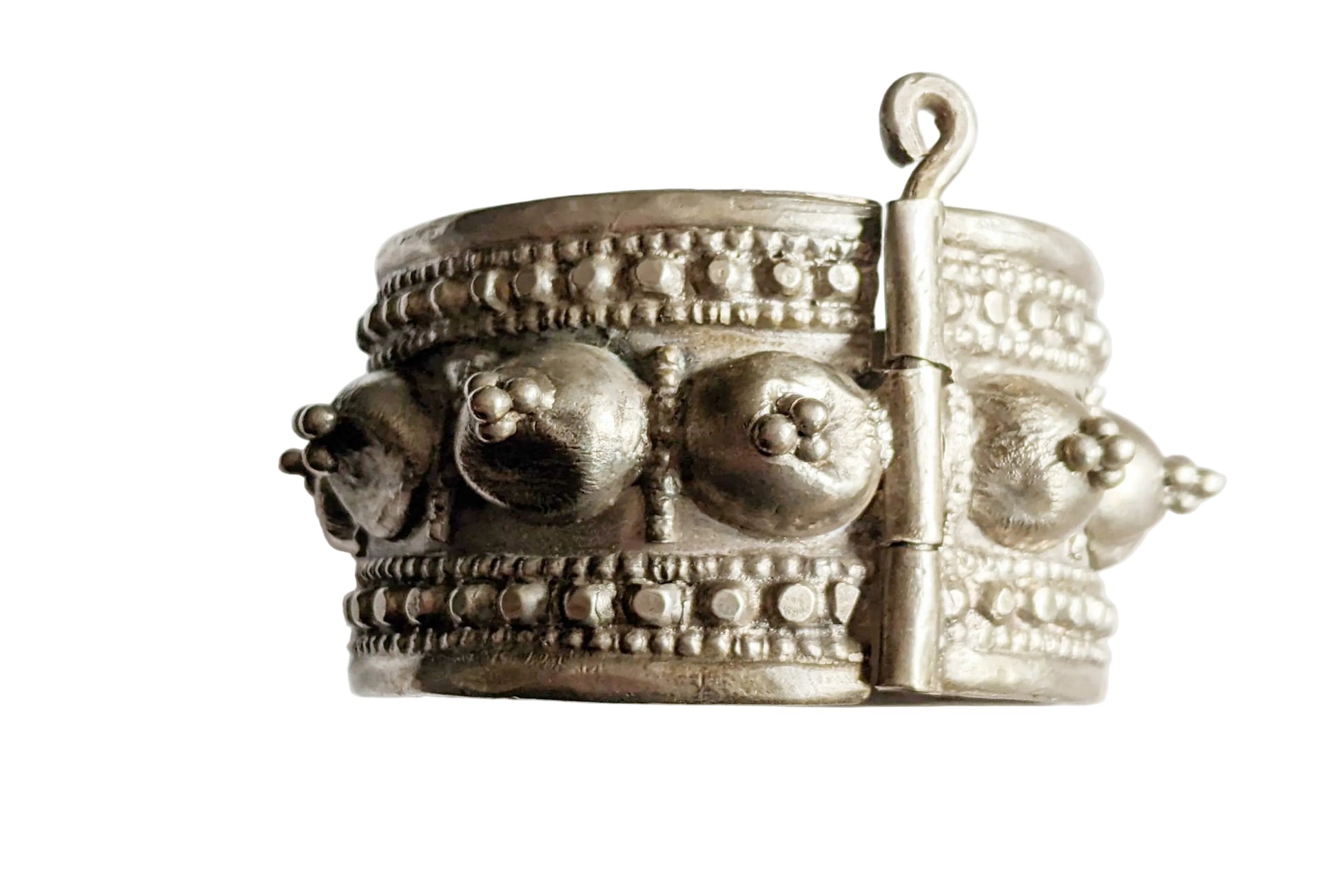 Silver bracelet with intricate designs on a white background