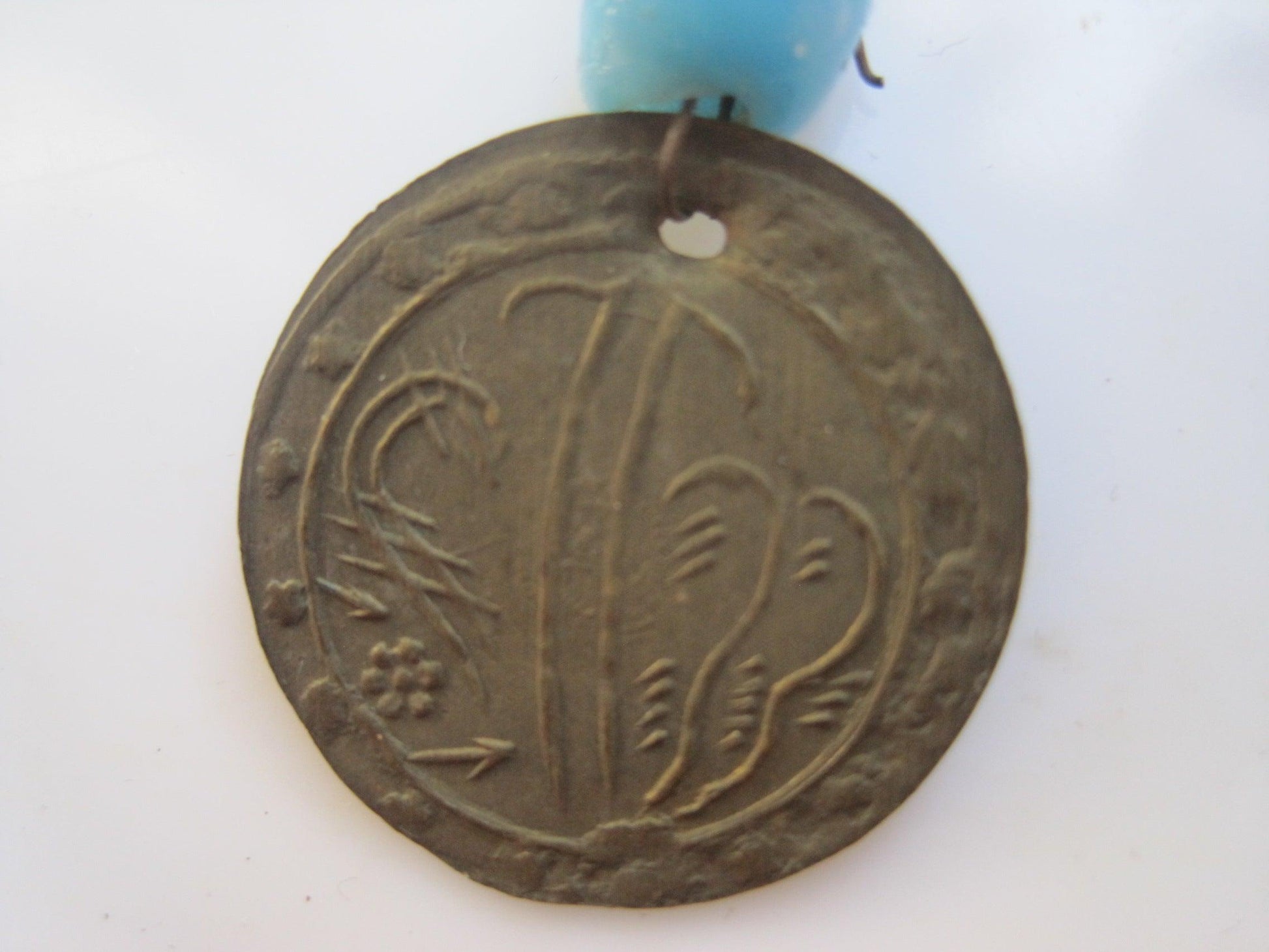 coin pendant on African necklace