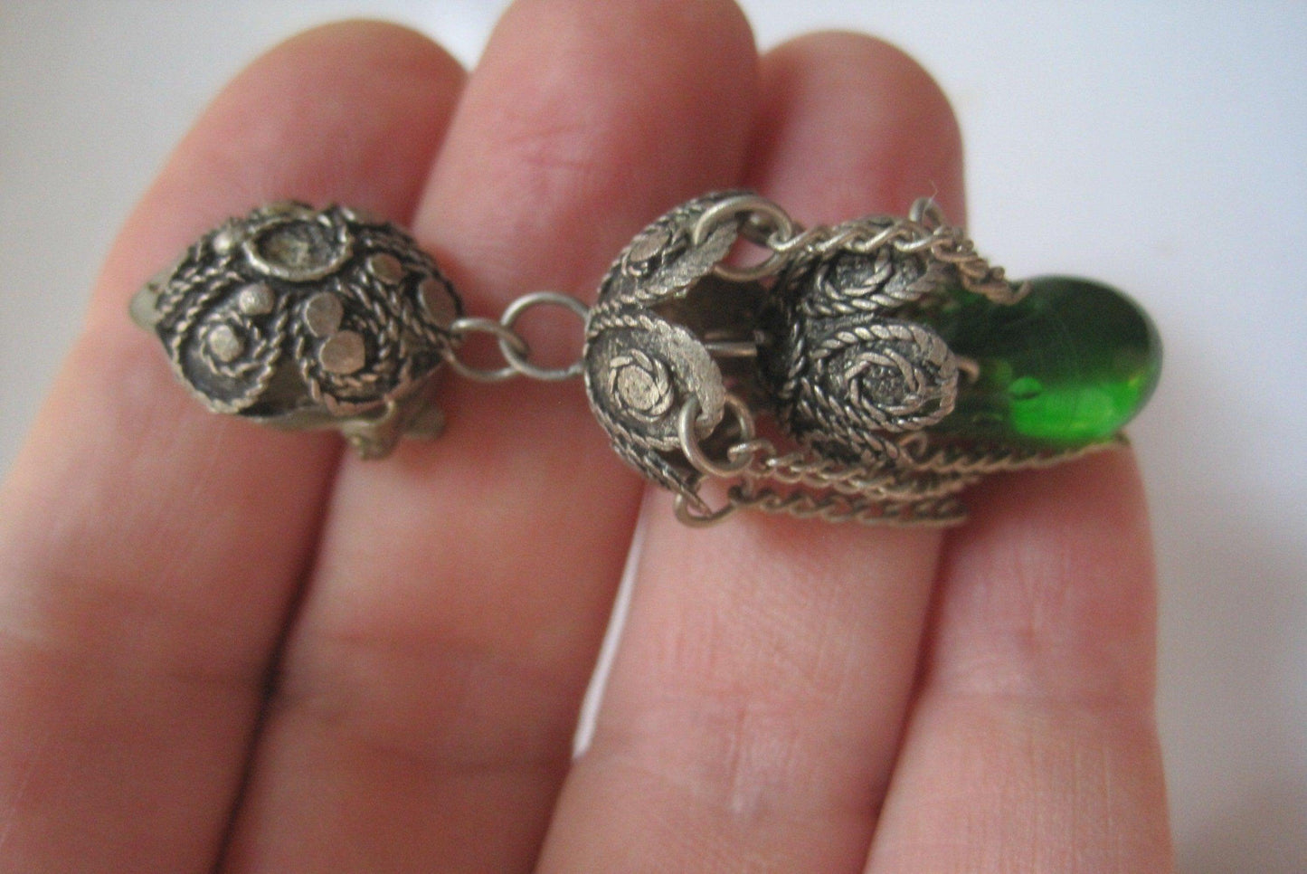 silver filigree and green glass